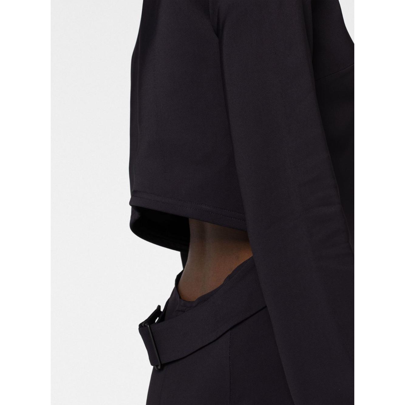 Side view of 'Kicked Back' black dress by 032C featuring cut-out detailing, structured fit, and rear zip fastening.