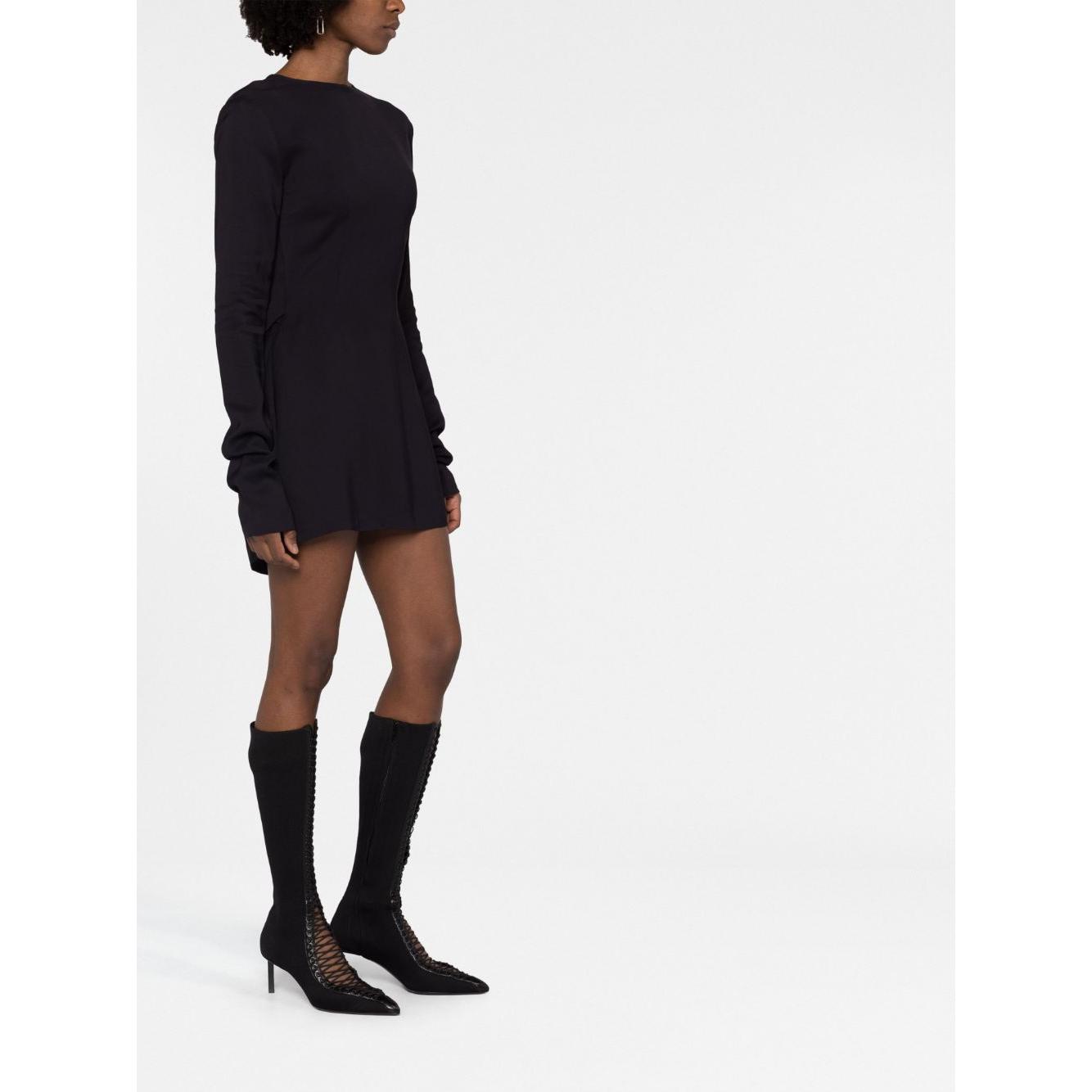 032C black structured short dress with cut-out detailing, round neck, long sleeves and straight hem, worn by model with boots.