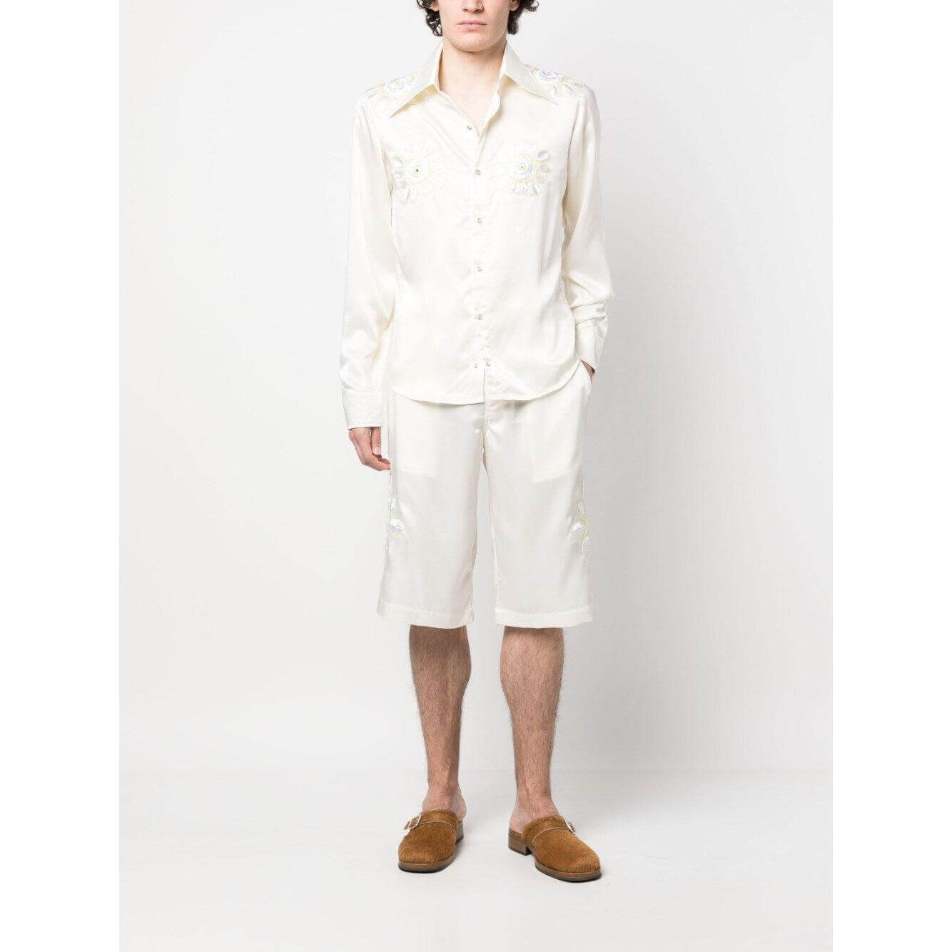 Model wearing cream white BLUEMARBLE embroidered satin shorts with belt loops, knee-length fit, and side pockets.