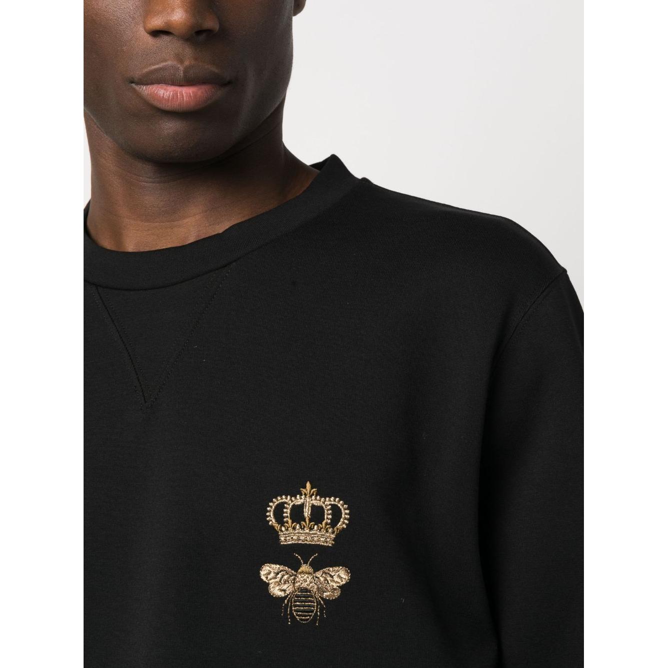 Black Dolce & Gabbana sweatshirt with embroidered bee and crown detail, crew neck, long sleeves, worn by model. Size 48 (IT).