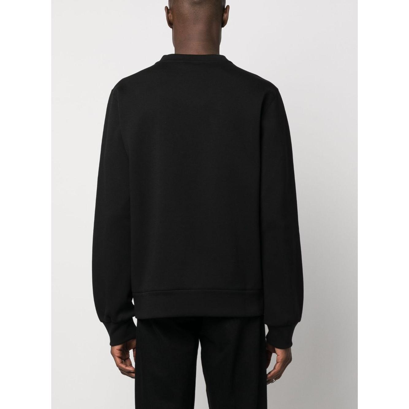 Back view of black Dolce & Gabbana embroidered sweatshirt with long sleeves and crew neck, worn by model. Cotton blend jersey texture.