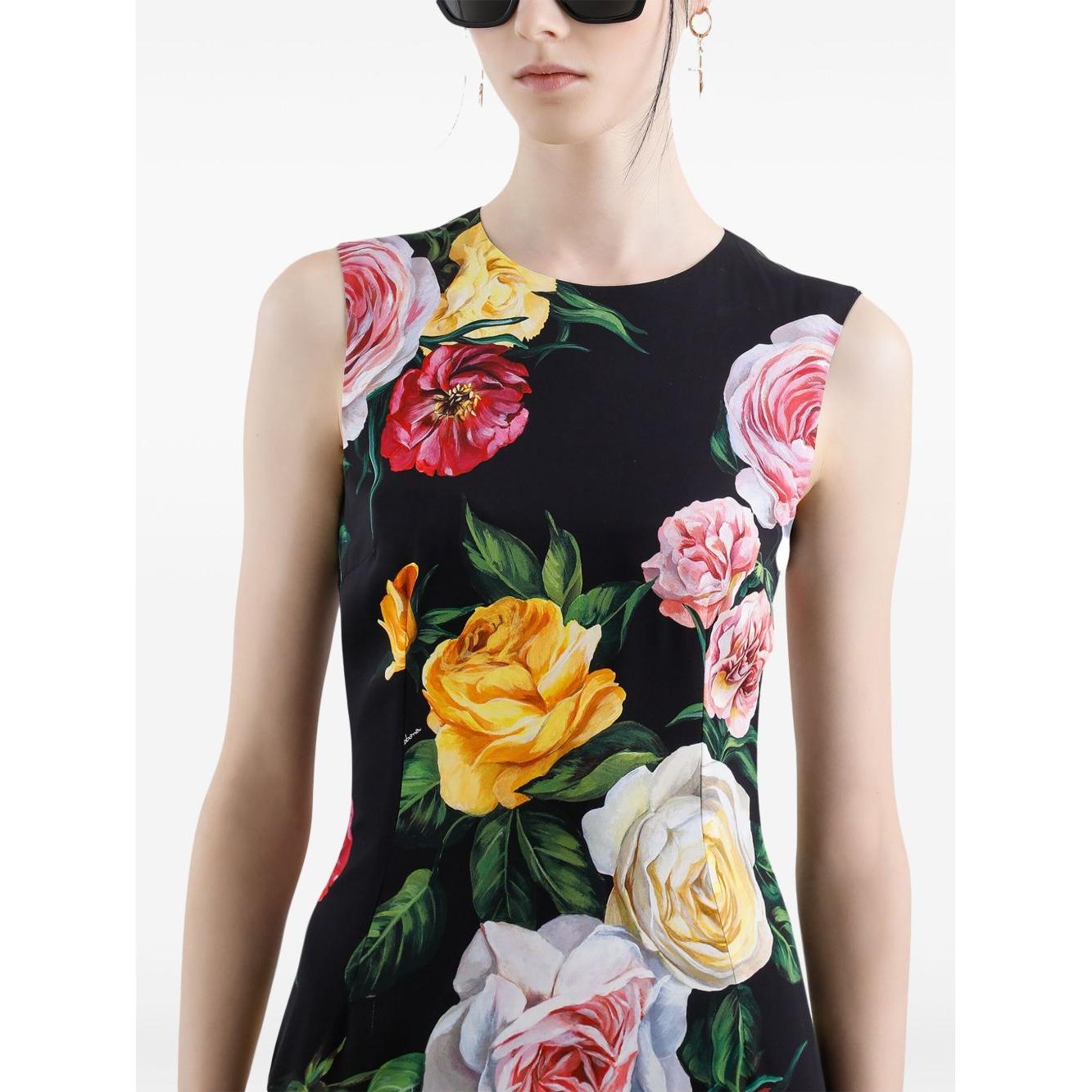 Dolce & Gabbana black sleeveless midi dress with vibrant floral print, round neck, modeled with concealed rear fastening.