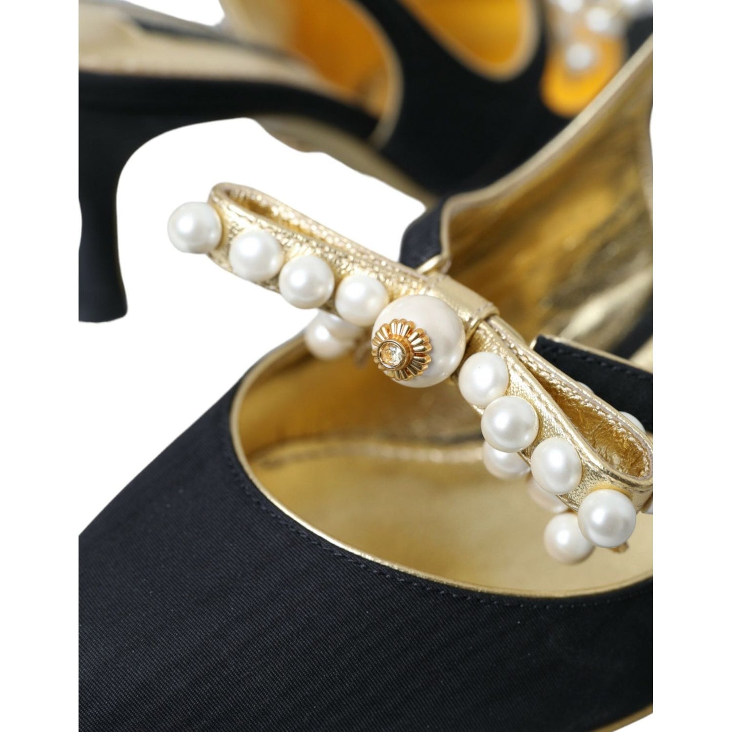 Close-up of Dolce & Gabbana black leather slingback shoes with faux pearls and gold accents.