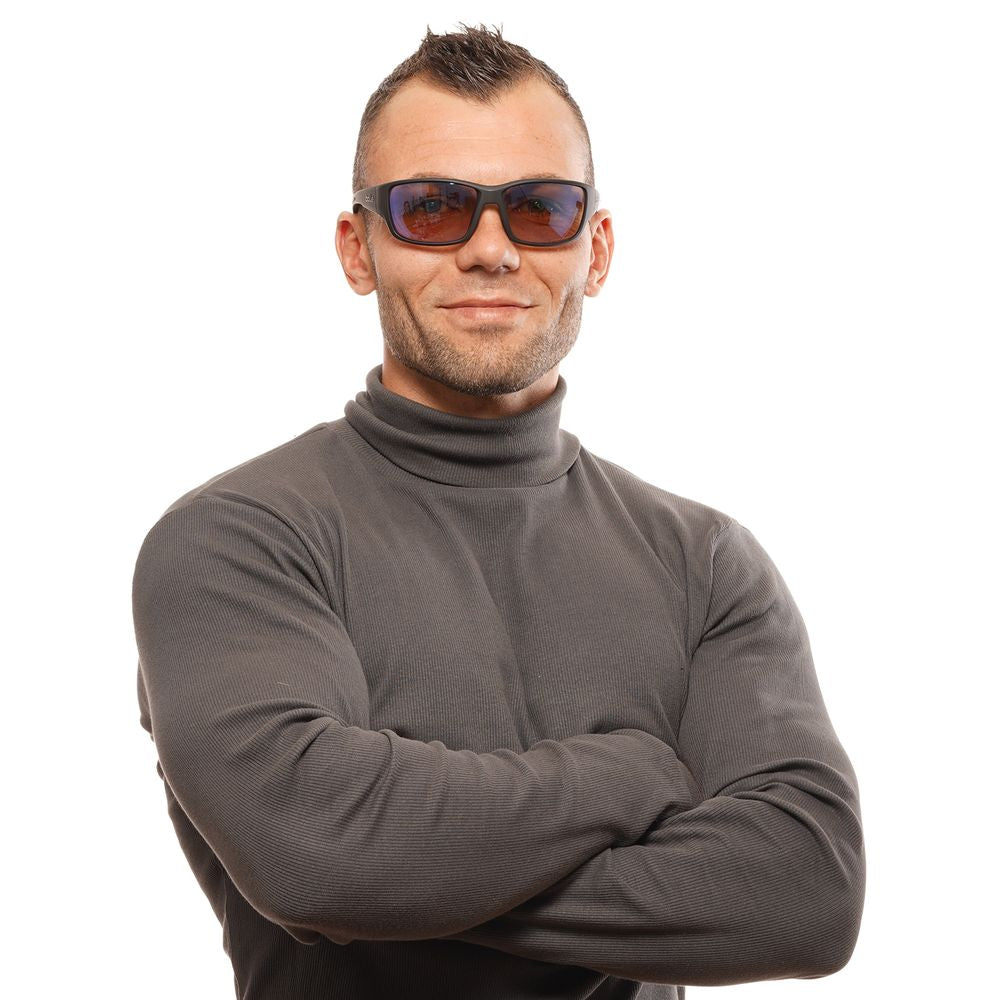 Person wearing Bolle black unisex sunglasses with brown lenses and full-rim plastic frame, showcasing a stylish trapezium shape.