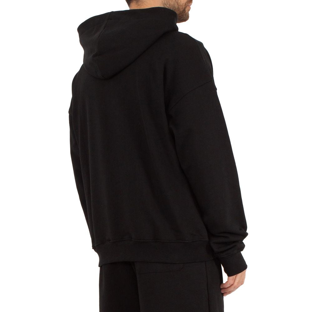 Comme Des Fuckdown black cotton sweater with hood, back view, worn by model. Features include zip closure and front pockets.