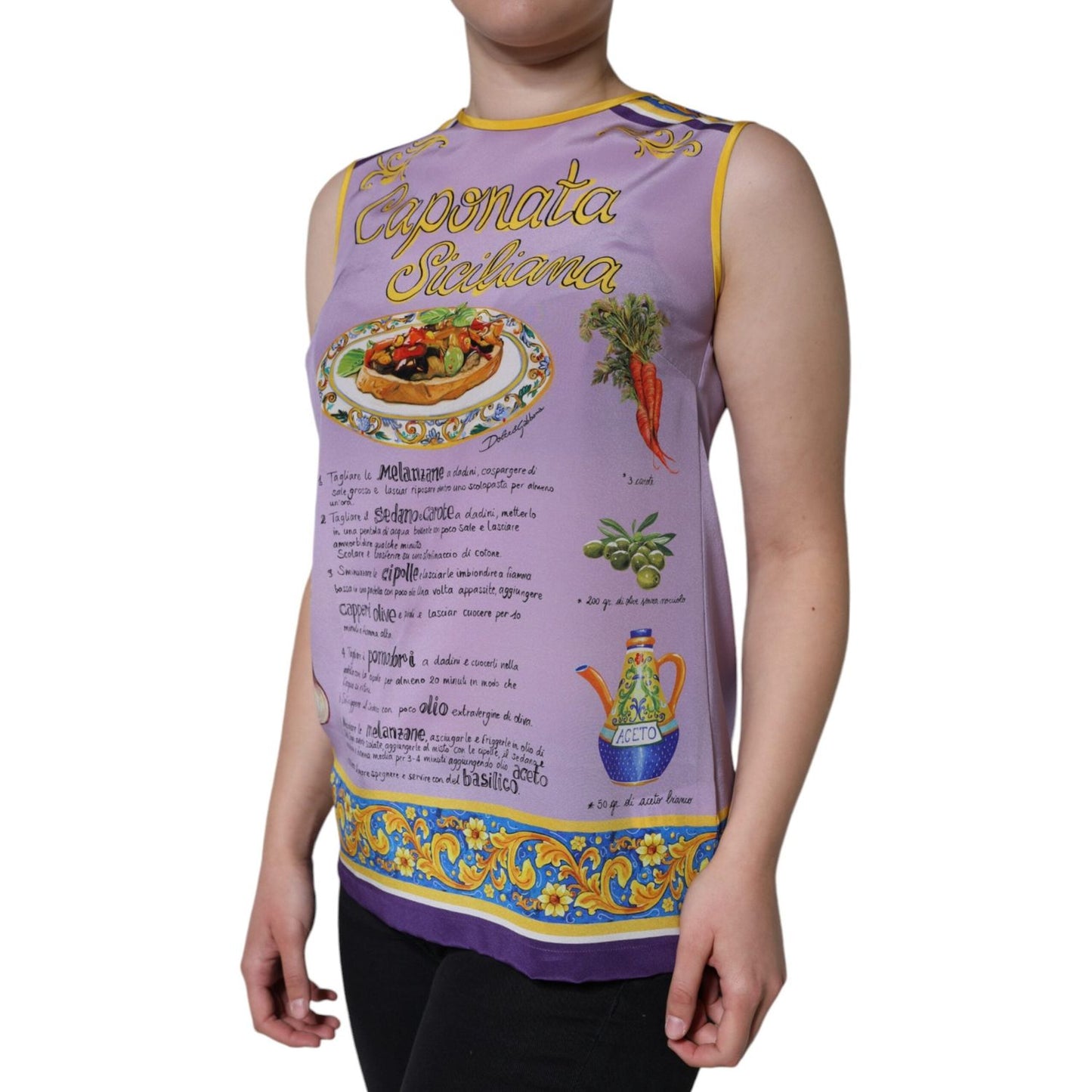 Dolce & Gabbana purple silk tank top with Caponata Siciliana print, sleeveless and round neck, modeled by a person. Made in Italy.