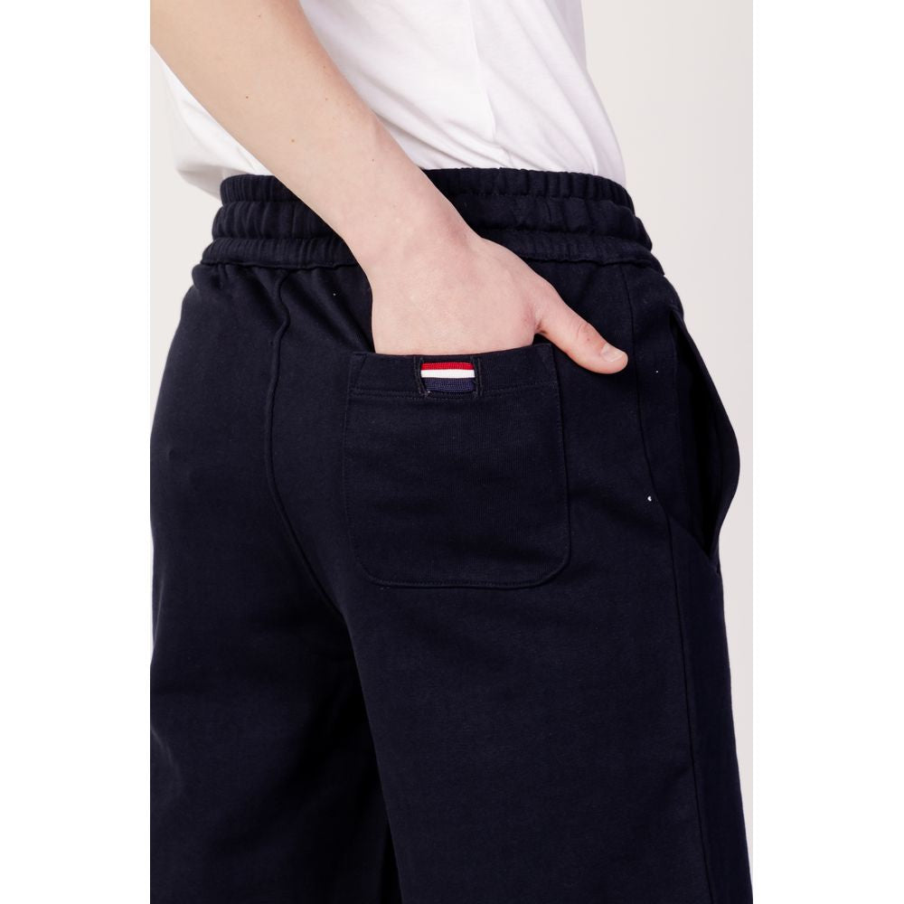 Side view of person wearing U.S. POLO ASSN. blue cotton shorts, showcasing back pocket detail from spring/summer collection.