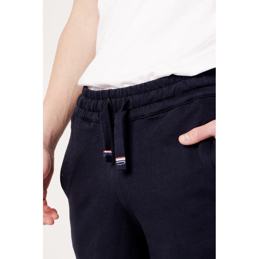 Close-up view of a person wearing blue cotton U.S. Polo Assn. shorts, part of the men's Bermuda Spring/Summer collection.