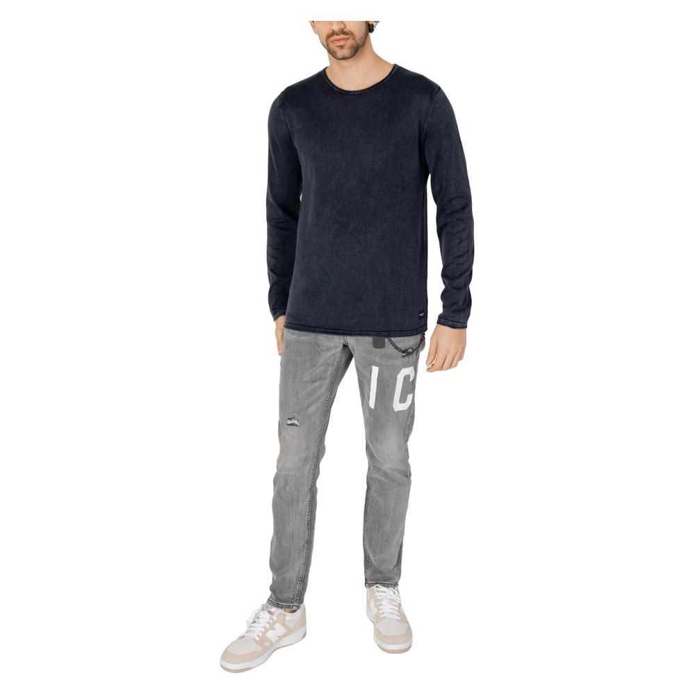 Men's casual outfit with a dark long-sleeve shirt and grey jeans with white sneakers, showcasing a relaxed style.