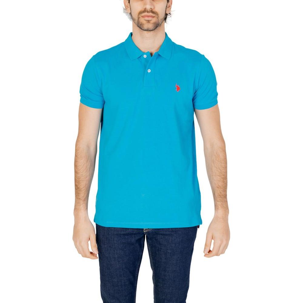 Man wearing U.S. Polo Assn. blue cotton polo shirt with embroidered logo, showcasing classic style and comfort.