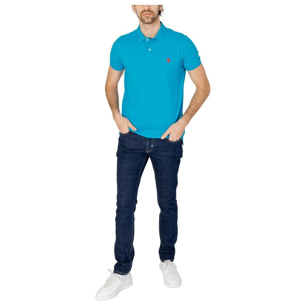 Man wearing U.S. Polo Assn. blue cotton polo shirt with jeans and white sneakers