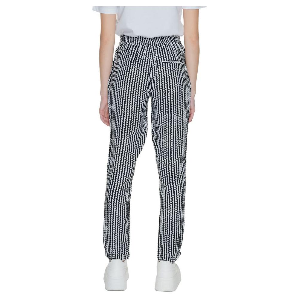 Women's black and white viscose pants, regular fit, spring/summer collection, back view with zipper detail, 100% viscose fabric.