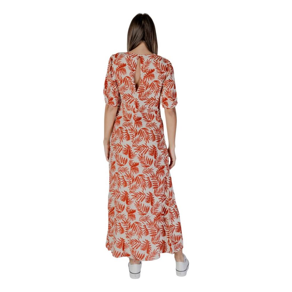 Back view of a woman wearing a B.Young red viscose dress featuring a spring/summer leaf pattern.