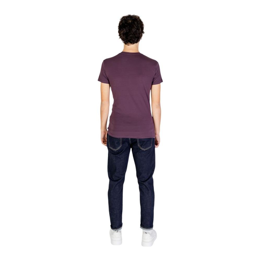 Back view of model wearing Emporio Armani purple cotton t-shirt with jeans, showcasing simple, refined design and perfect casual fit.