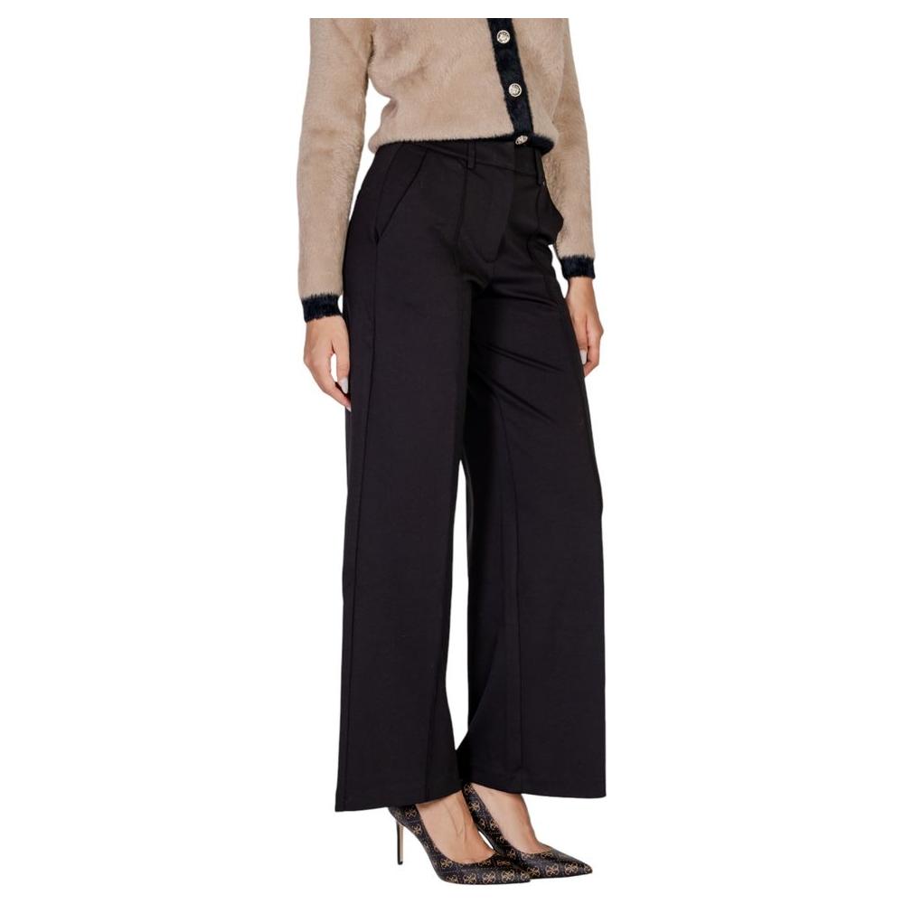 Woman wearing ICHI black polyester fall/winter pants with viscose and elastane, wide-leg style.