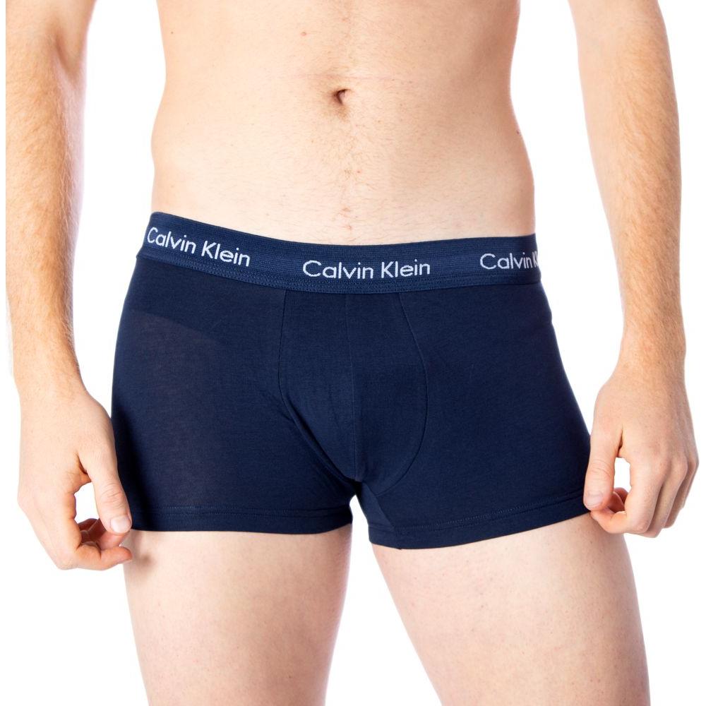 Model wearing Calvin Klein blue cotton underwear with logo waistband, offering comfort and style with a soft fit for men.