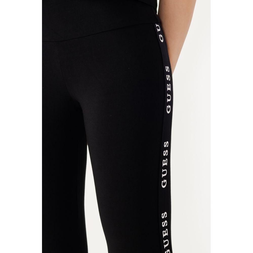 Black Guess Active women's leggings with side logo, featuring high waist and fitted design for comfort and style in sports activities.