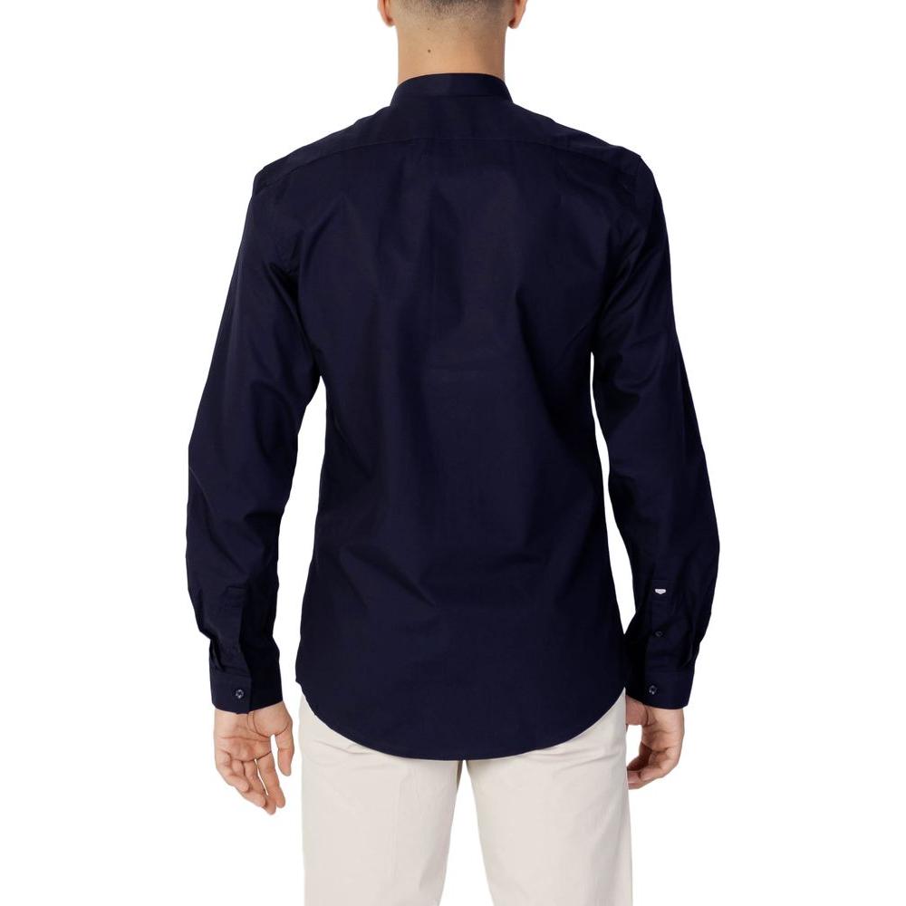 Back view of a man wearing an Antony Morato blue cotton shirt, showcasing a slim fit design, perfect for formal and casual styles.