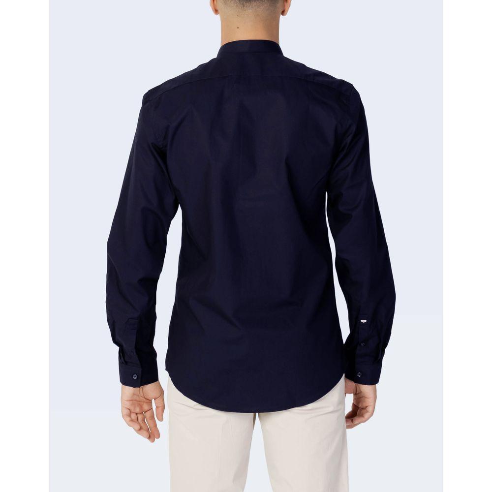 Back view of Antony Morato blue cotton slim fit shirt, shown on a man wearing beige pants, ideal for formal or casual occasions.