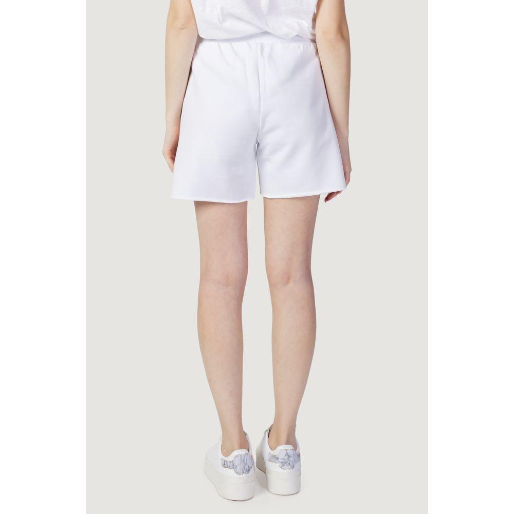 Back view of woman wearing Blauer white cotton sports pants, spring/summer collection, styled with casual white sneakers.