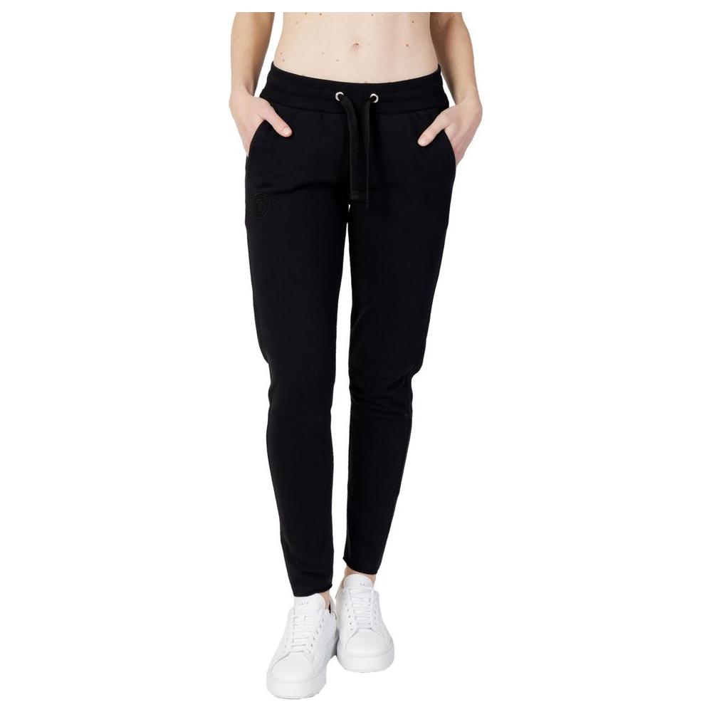 Women's Blauer black cotton sport pants for spring/summer; featuring pockets and drawstring; casual style with white sneakers.