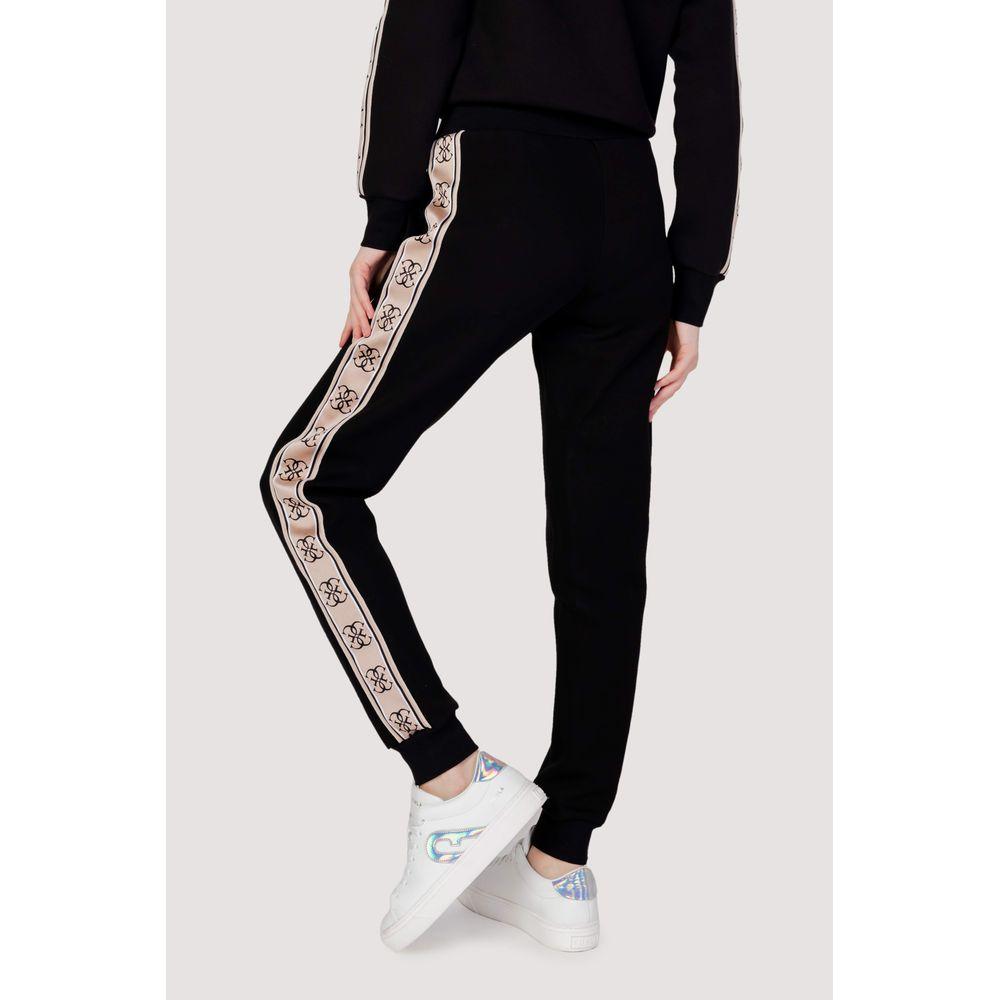 Black cotton joggers with side stripe detail, worn by model, showcasing sleek design and comfortable fit, perfect for casual wear.