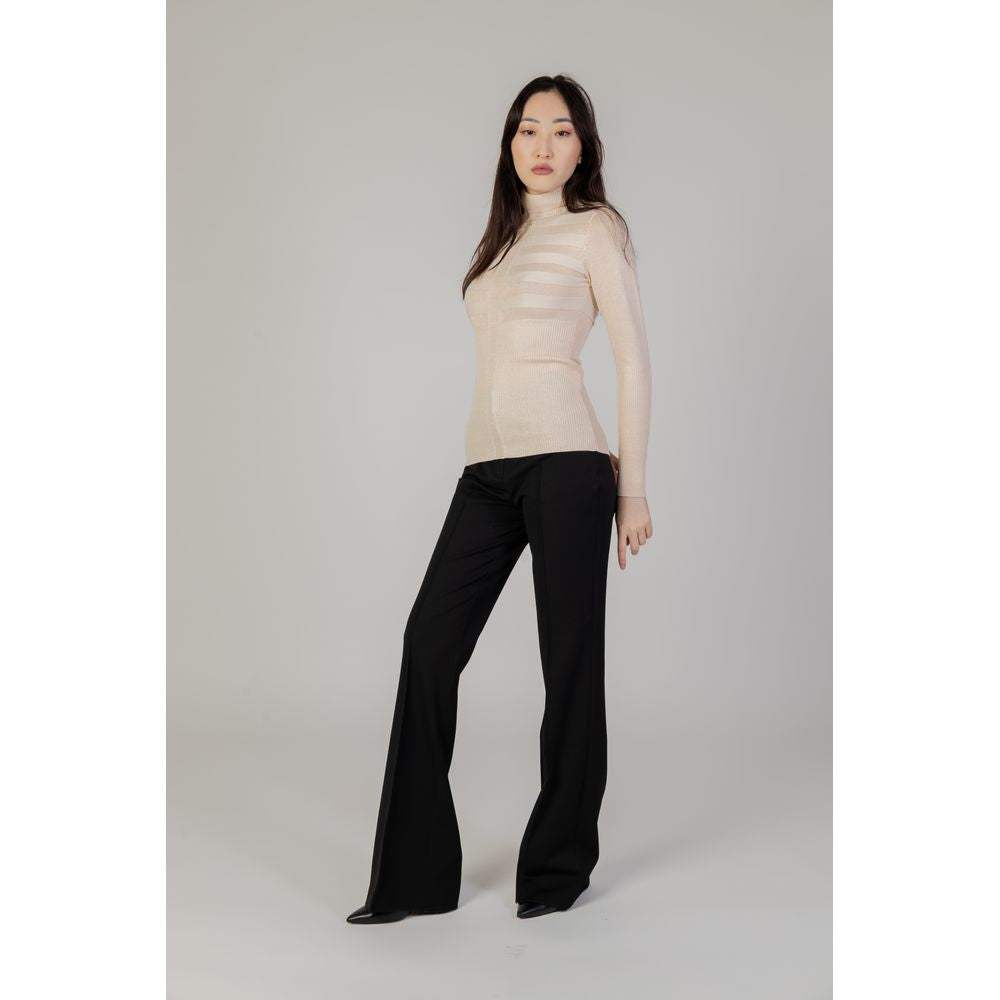 Woman wearing Morgan De Toi pink viscose sweater from fall/winter collection with black pants showcasing women's knitwear fashion.