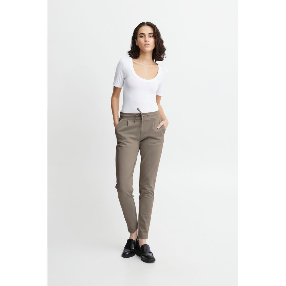 Woman wearing ICHI gray polyester cigarette pants for fall/winter collection, featuring a blend of polyester, viscose, and elastane.