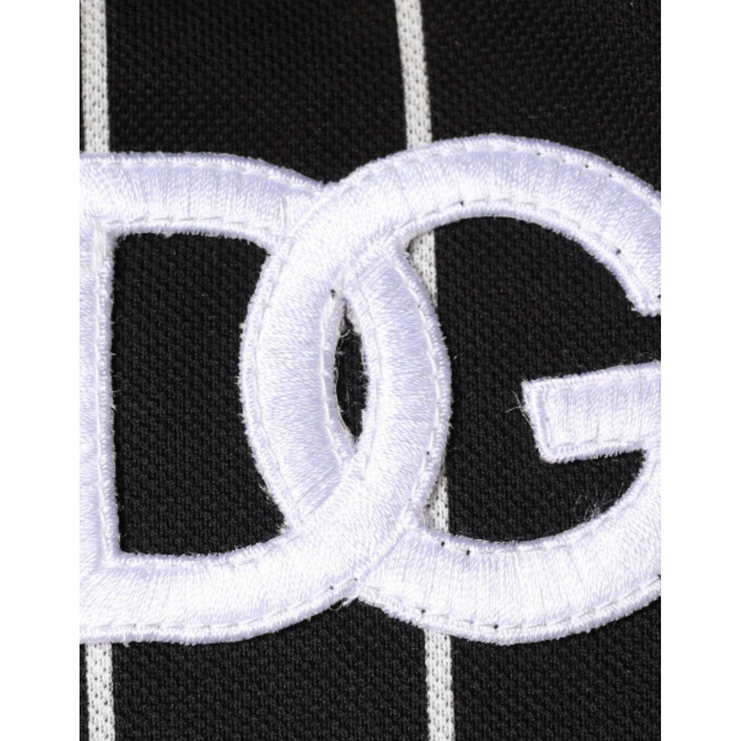 Close-up of Dolce & Gabbana logo embroidery on black and white striped fabric.