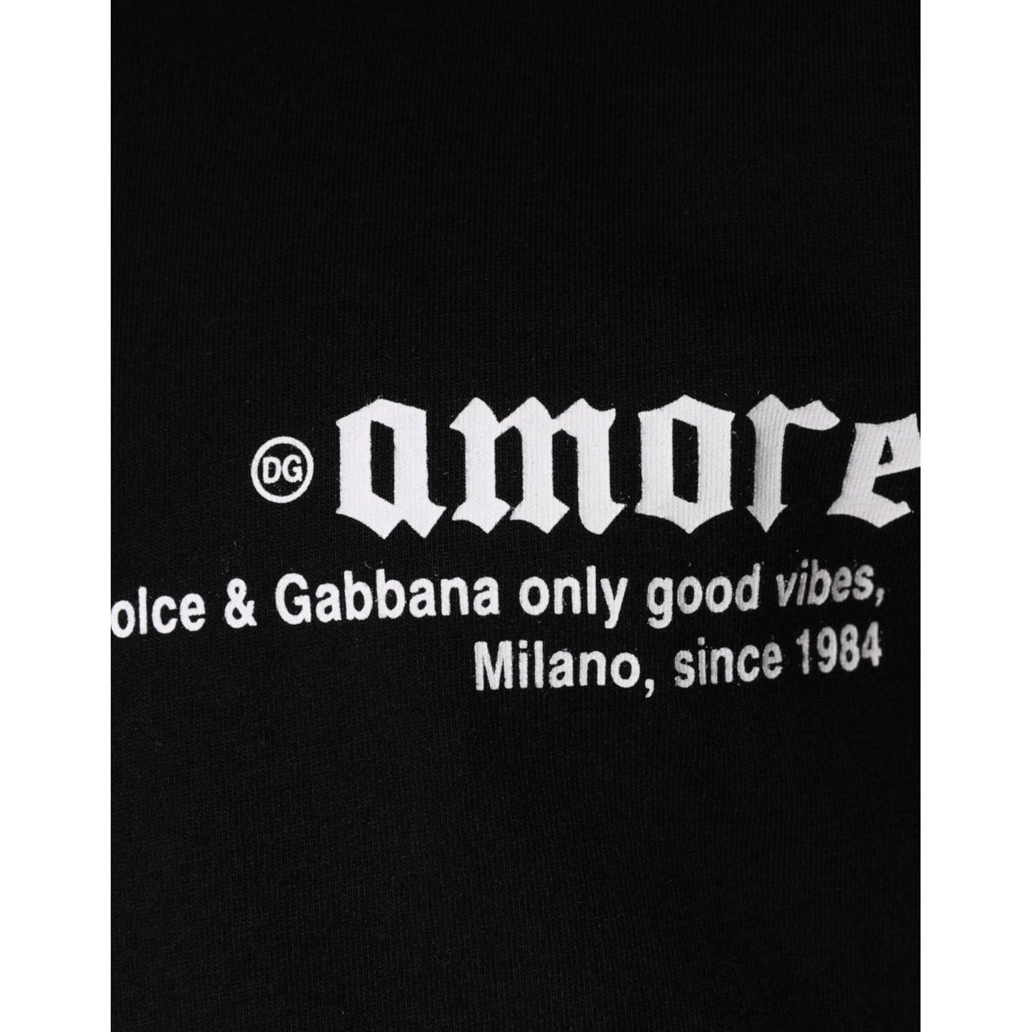 Close-up of Dolce & Gabbana Amore print on black cotton crew neck t-shirt with logo and text detail.