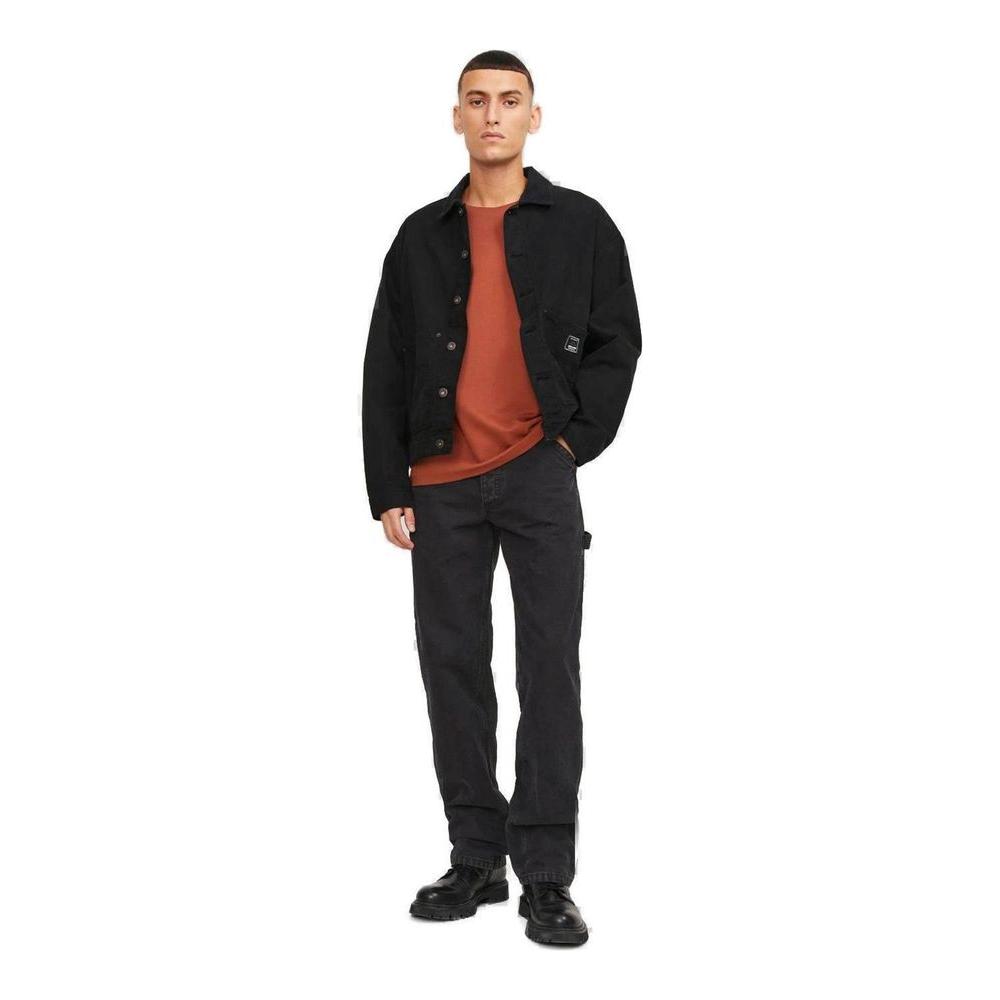 Model wearing Jack Jones black cotton jeans and pants, perfect for men's spring/summer fashion, made from 100% cotton.