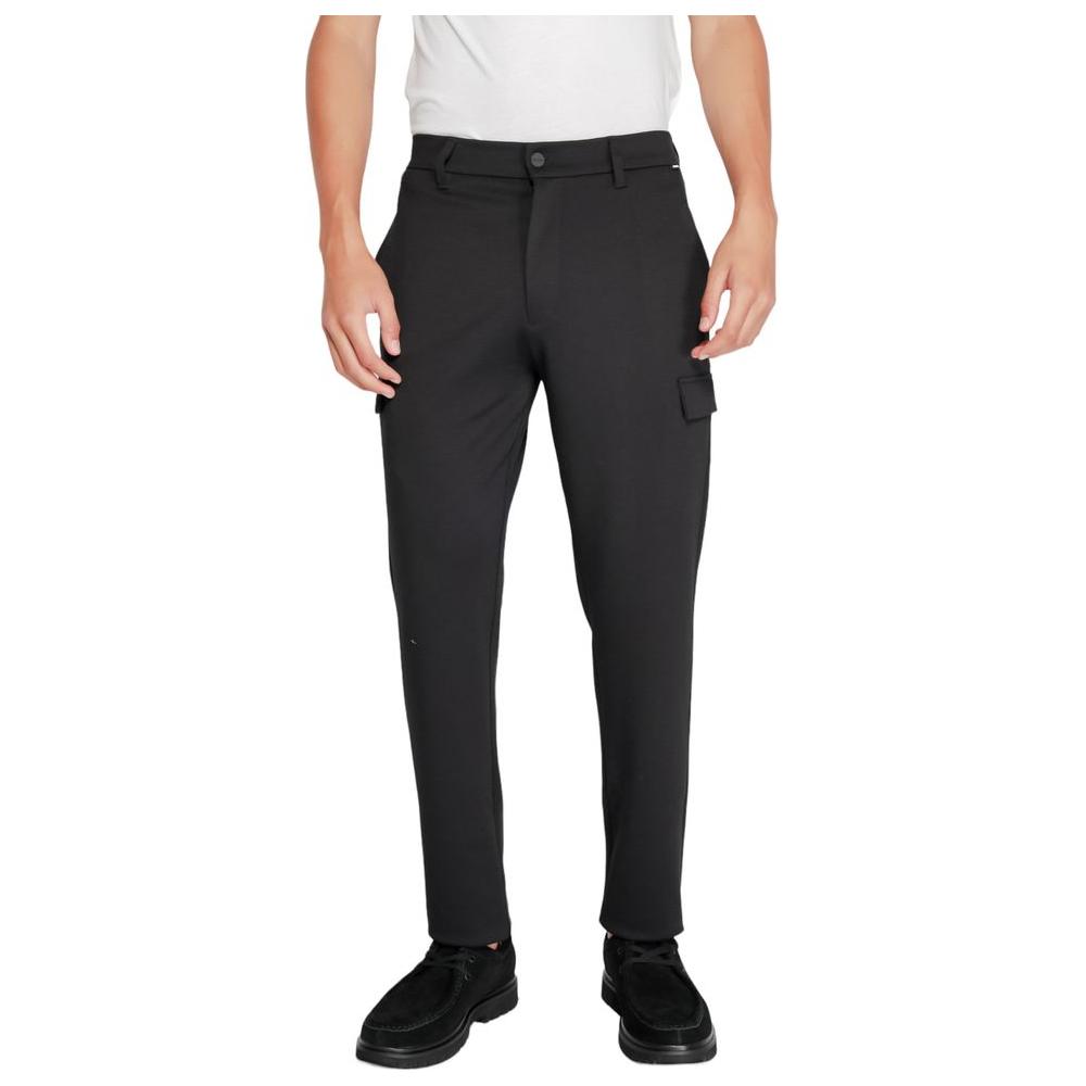 Man wearing Calvin Klein Black Recycled Polyester Jeans with modern fit and sustainable materials for eco-friendly fashion.