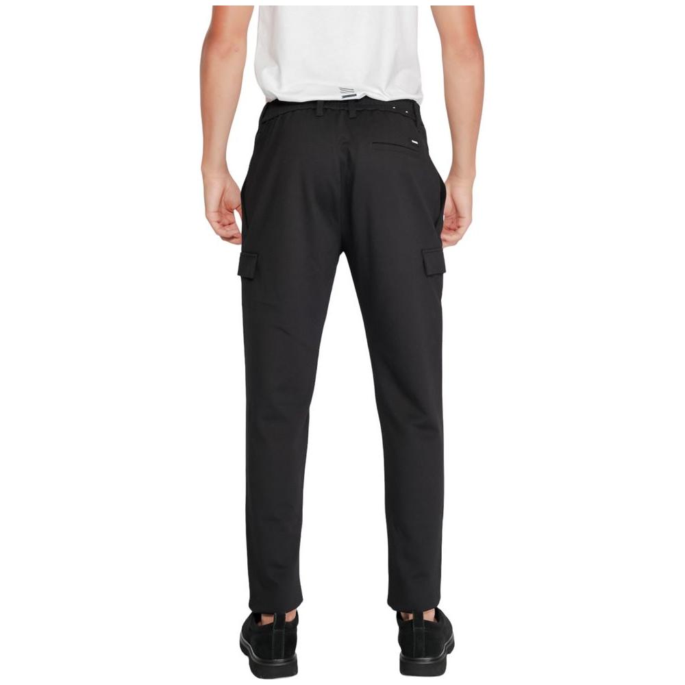Back view of Calvin Klein black tapered sports pants, showing pockets and sustainable design for men, model K10K113487.