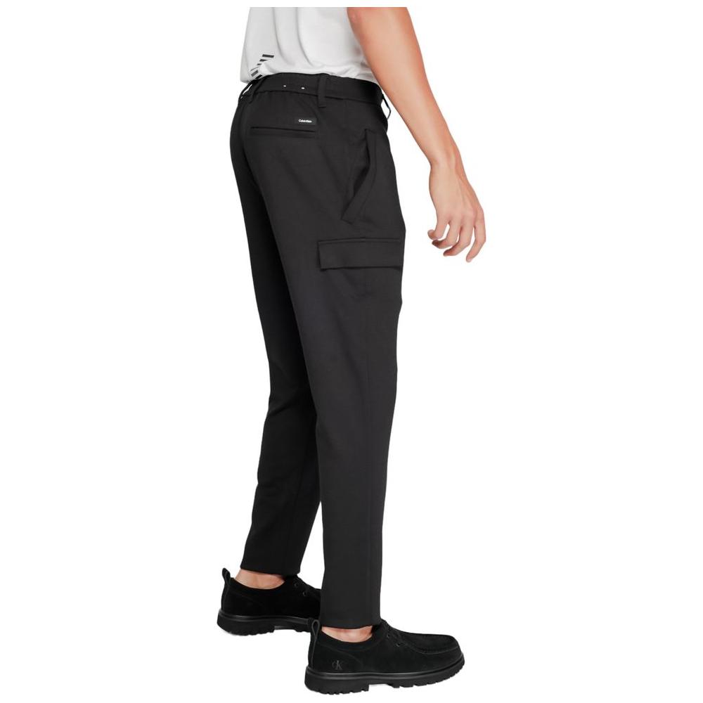 Back view of Calvin Klein black tapered sports pants made with recycled polyester and sustainable viscose, featuring elastic fit.