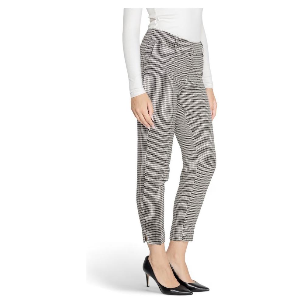 Woman wearing black and white checkered ankle-length pants with high heels.