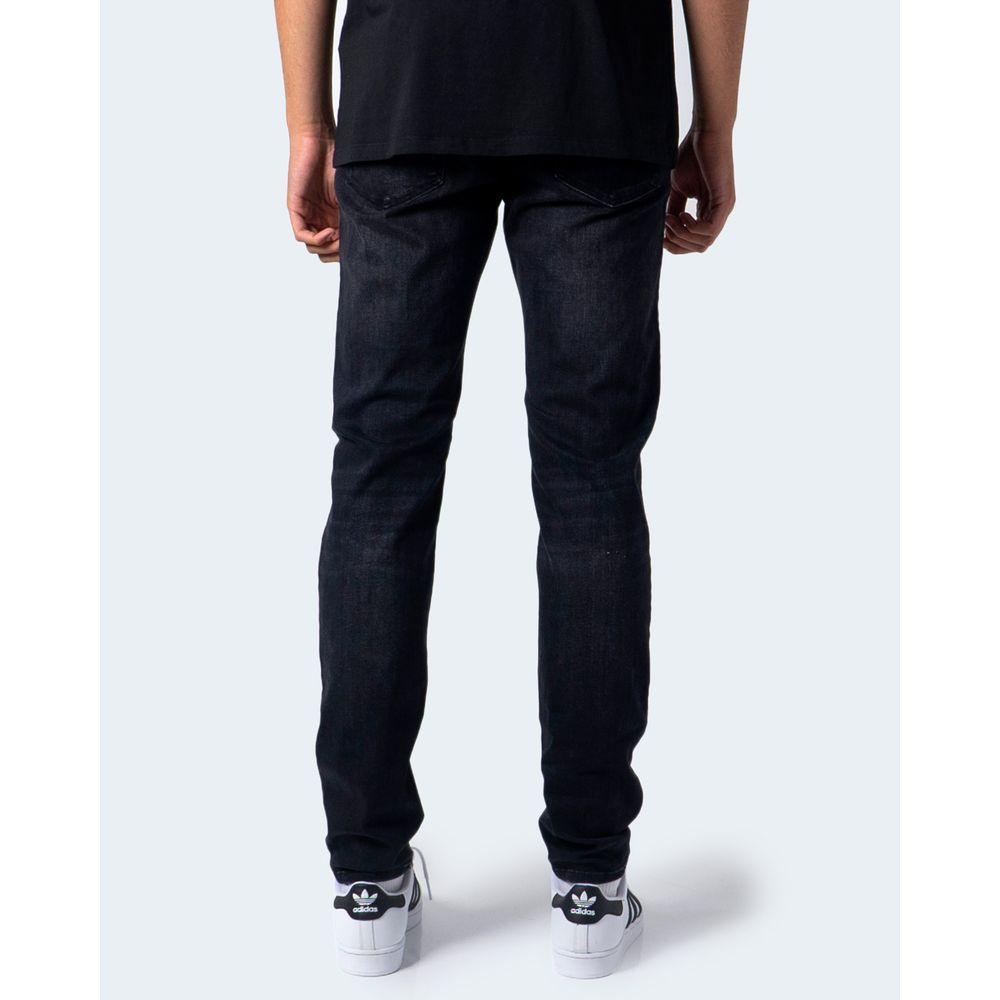Back view of a man wearing Jack Jones black slim jeans, showcasing the fit and style, paired with white sneakers.
