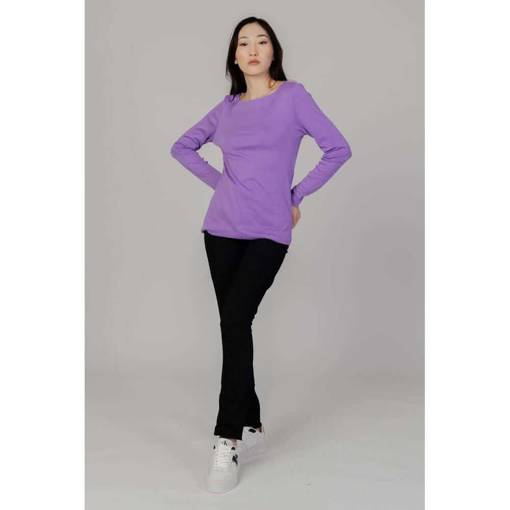Woman wearing Street One black cotton slim jeans for fall/winter collection with purple top, showcasing casual style.