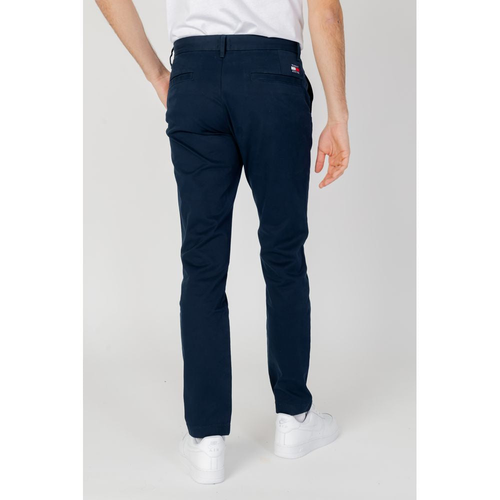 Back view of blue Tommy Hilfiger men's tapered pants made of 96% organic cotton, perfect for spring/summer collection.