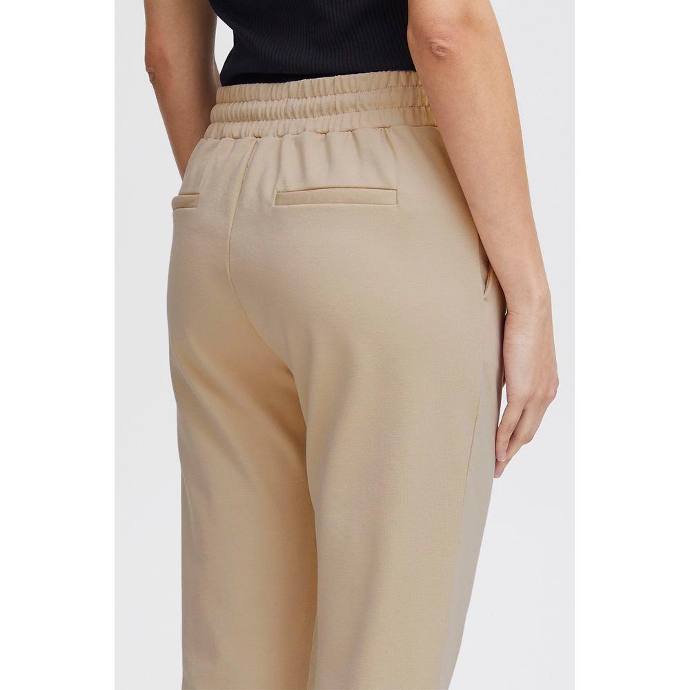Back view of ICHI beige polyester women's cigarette pants, fall/winter collection, featuring elastic waistband and sleek design.