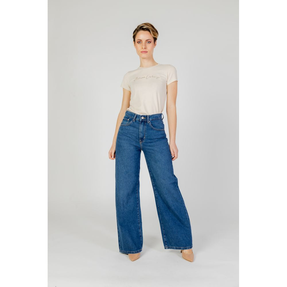 Women's baggy blue cotton jeans, part of the autumn/winter collection, showcasing relaxed fit and style.