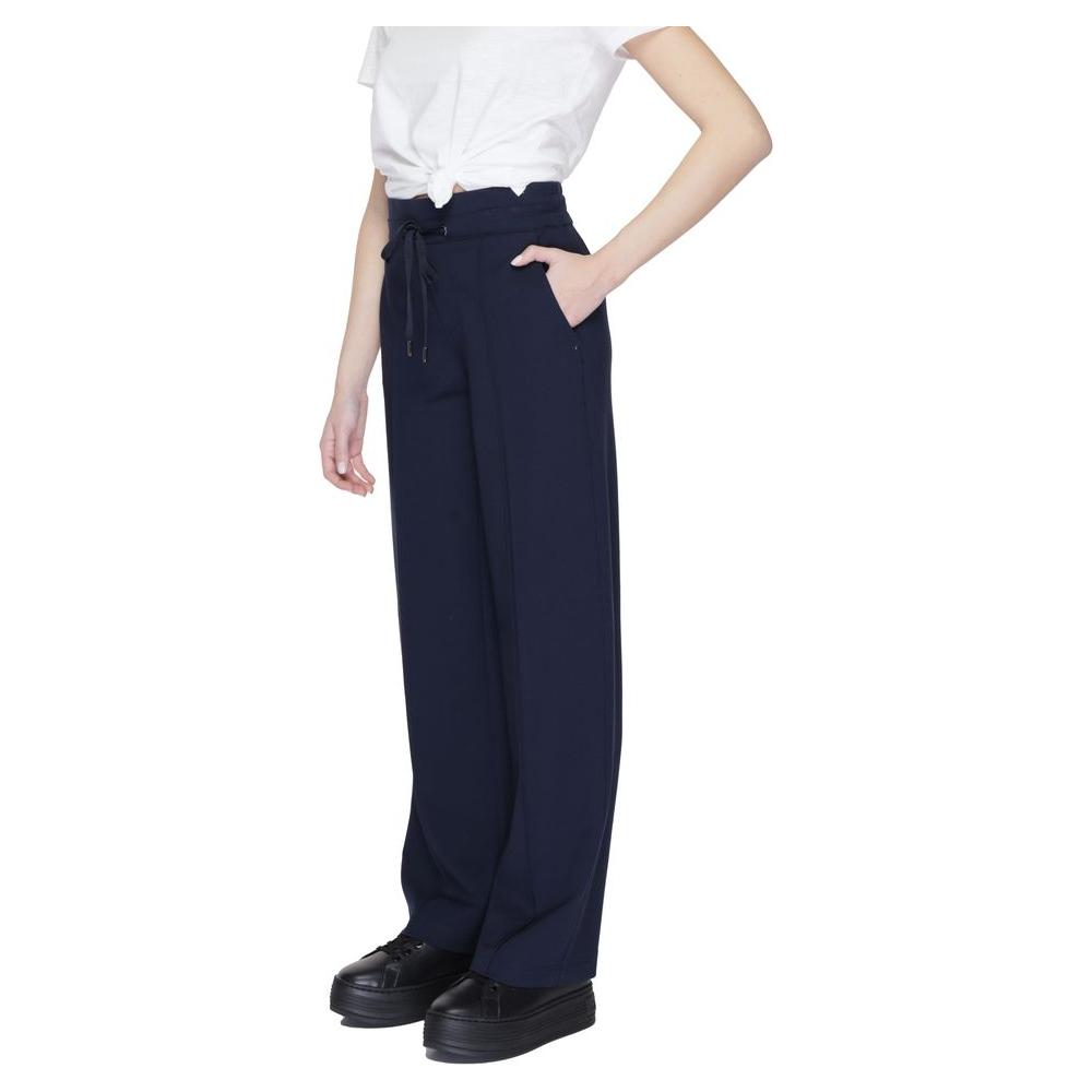 Model wearing Street One blue viscose palazzo trousers, spring/summer collection, featuring pockets and a tie waist.