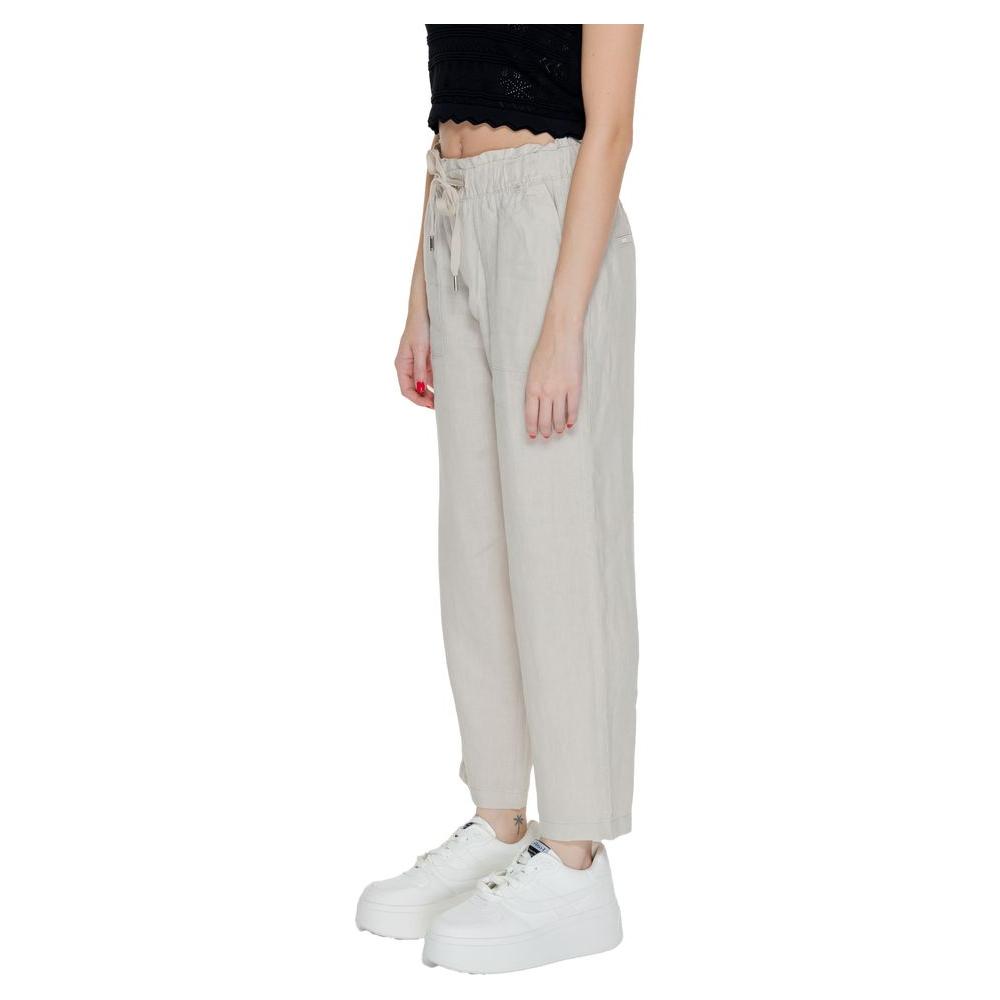 Woman wearing beige linen pants, part of Street One's spring/summer collection, made from 100% linen, perfect for regular fit styles.