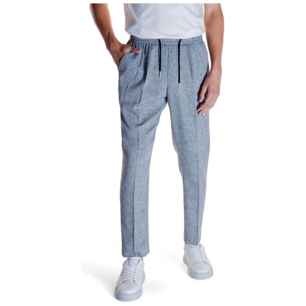 Men's grey linen pants with a comfortable fit, featuring front pockets and a drawstring waist, styled with white sneakers.