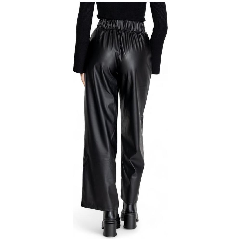 Woman wearing Jacqueline De Yong black polyester fall winter pants, back view. Ideal for women seeking stylish seasonal fashion.