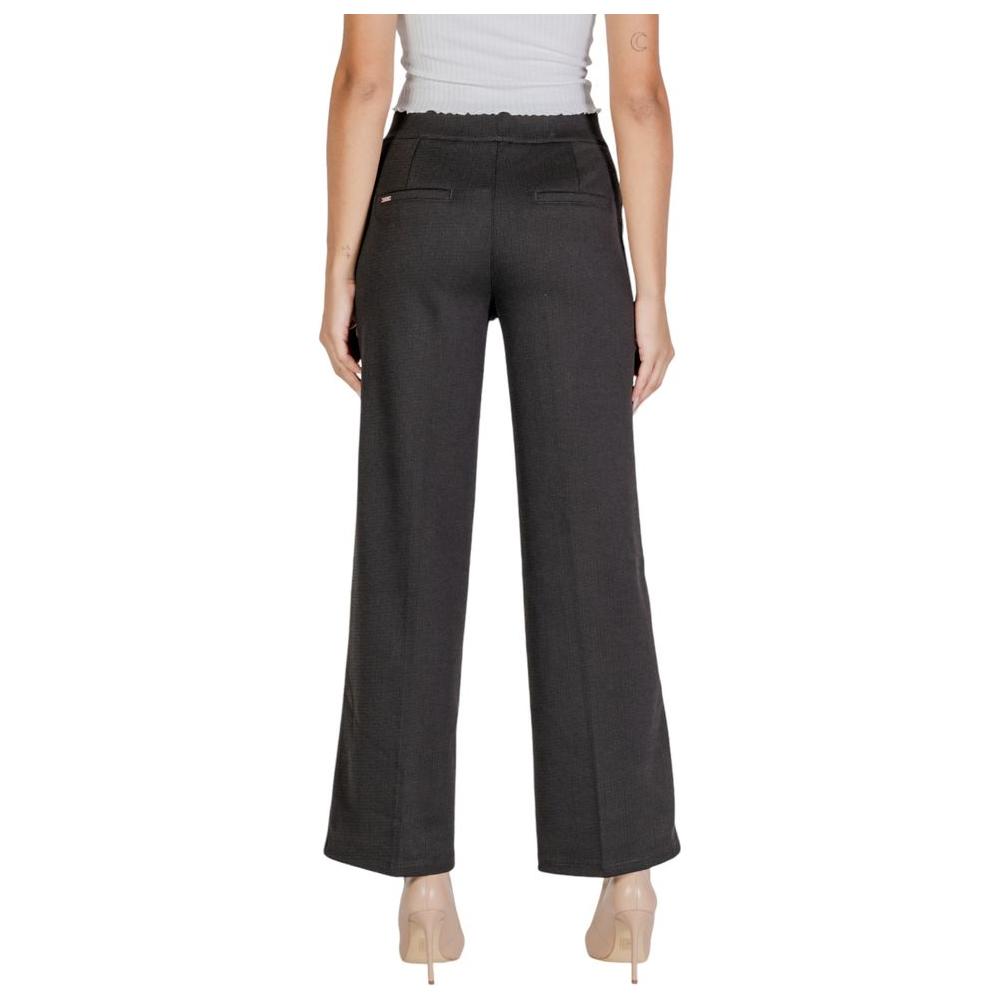 Woman wearing Street One black polyester jeans and pants for fall and winter collection, back view