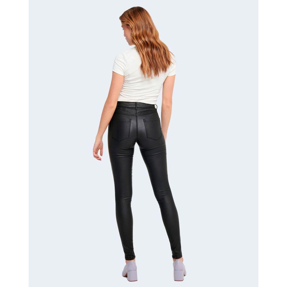 Woman wearing high-waist black viscose skinny jeans with rock coated finish, rear view, showcasing comfortable and snug fit.