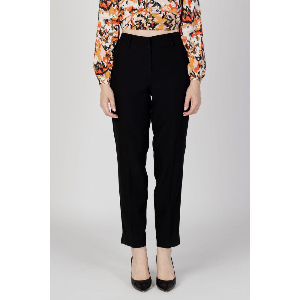 Women's black cigarette pants in recycled polyester, autumn/winter collection, eco-friendly fashion, front view.