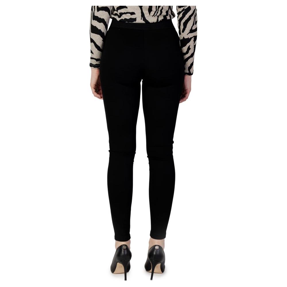 Woman wearing black viscose leggings, part of autumn/winter collection, 60% viscose, rear view with zebra print top and heels.