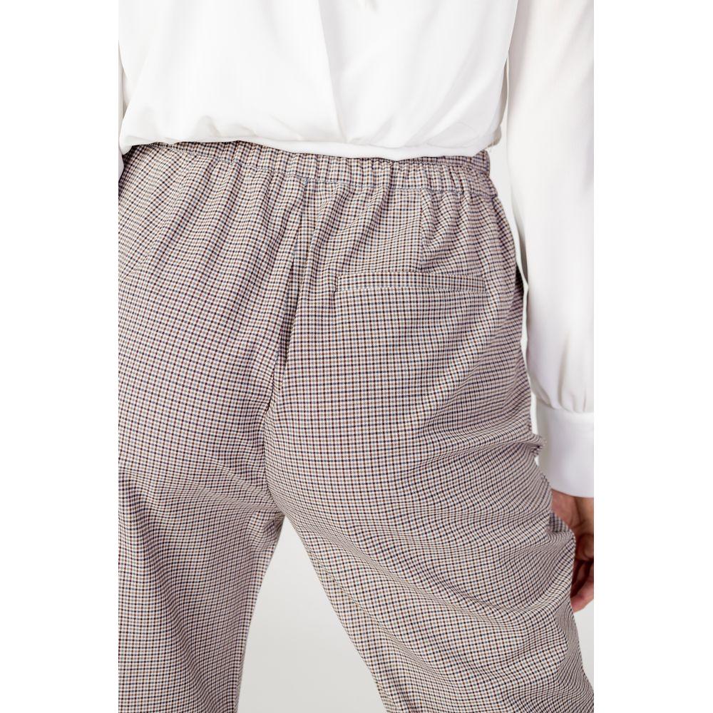 Back view of women's beige polyester cigarette pants with elastic waistband, part of autumn/winter collection.