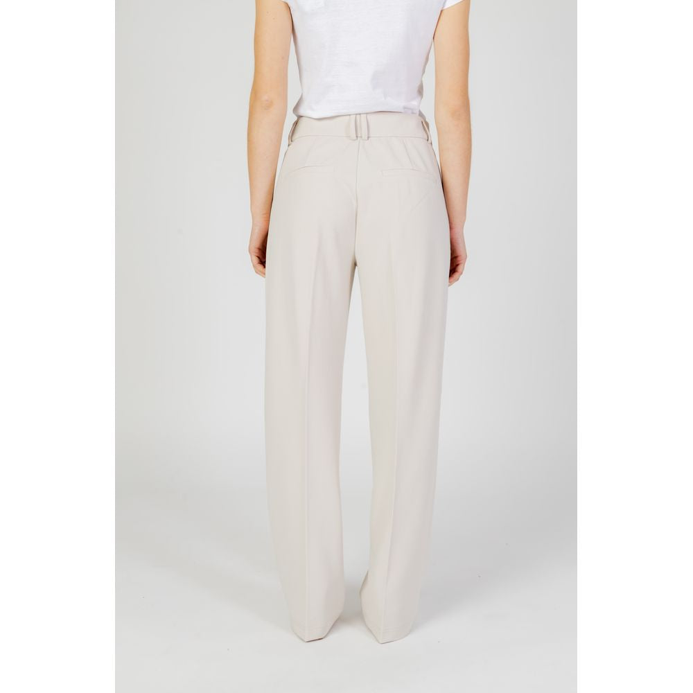 Back view of women's beige polyester cigarette pants from spring/summer collection.